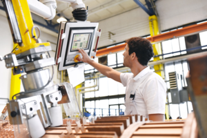 logistics in manufacturing - man adjusting machinery